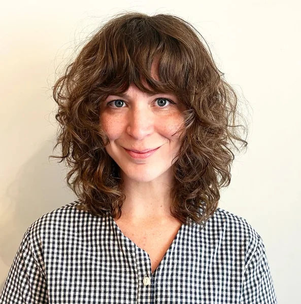 Curly Mid-Length Shag with Full Bangs