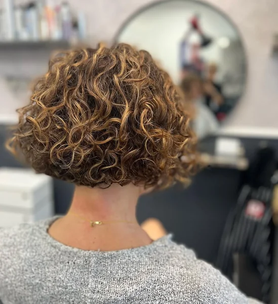 Dimensional Curly Bob with Stacked Layers and Highlights