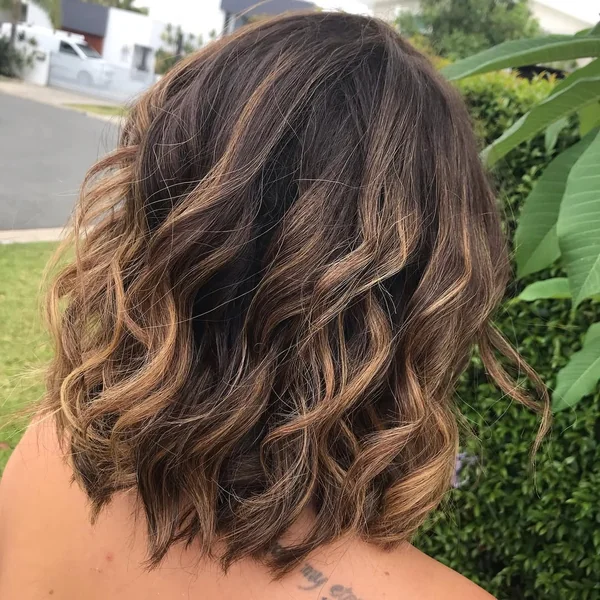 Dimensional Wavy Bob with Caramel Balayage Highlights