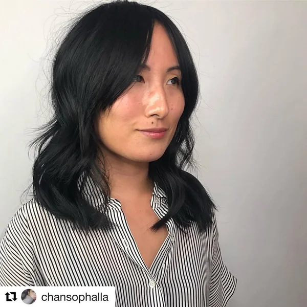Chic Jet Black Medium Cut with Soft Fringe and Waves