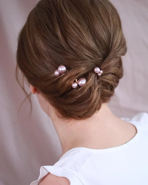 Elegant Low-Rolled Chignon with Pink Pearl Pins