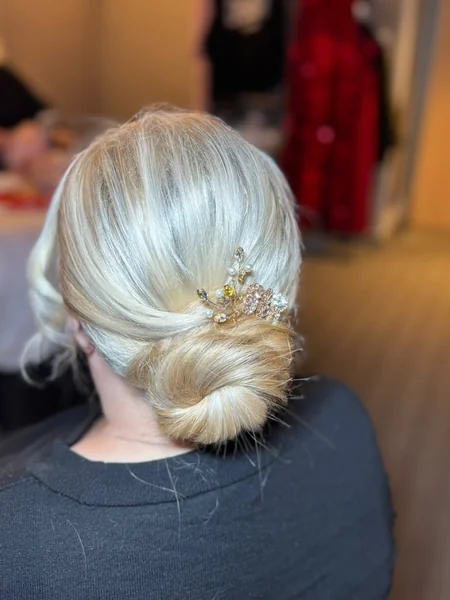 Elegant Low Blonde Bun with Delicate Gemstone Hair Comb