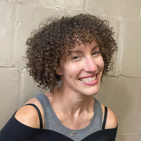 Rounded Toffee-Highlighted Curly Bob with Full Fringe
