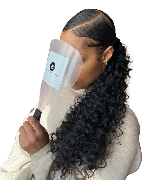 Sleek Low Ponytail with Voluminous Curly Texture
