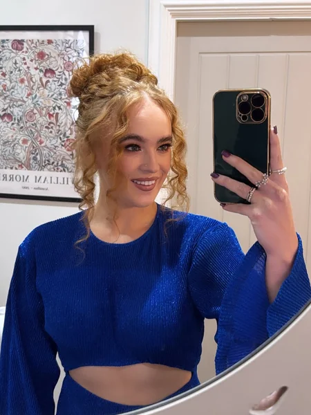Chic Braided Top Knot with Golden Curly Tendrils