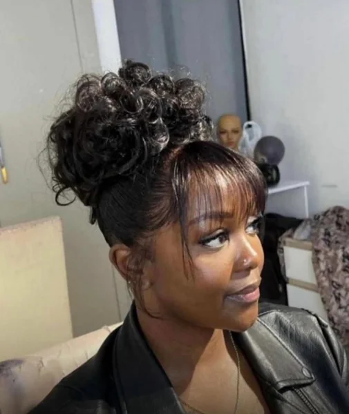 Sleek Top Knot with Curly Face-Framing Accents