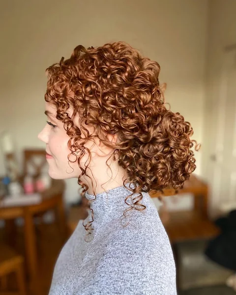 Vibrant Copper Ringlet Bun with Face-Framing Spirals