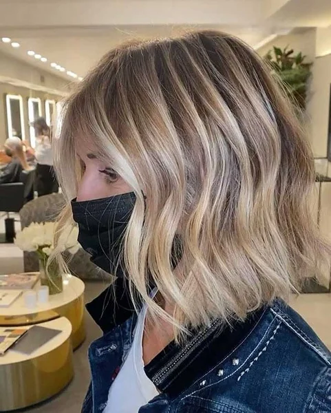 Wavy Sun-Kissed Long Angled Bob with Face-Framing Highlights