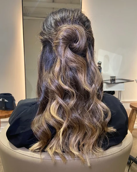 Elegant Brunette Half-Up Swirl with Polished Curls