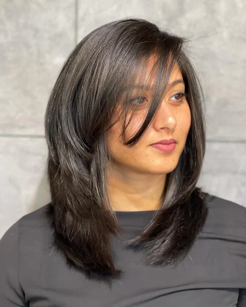 Dark Layered Lob with Side-Swept Bangs
