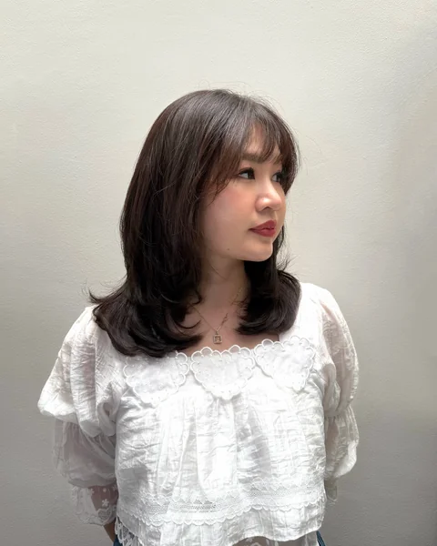 Layered Haircut with Blunt Curtain Bangs