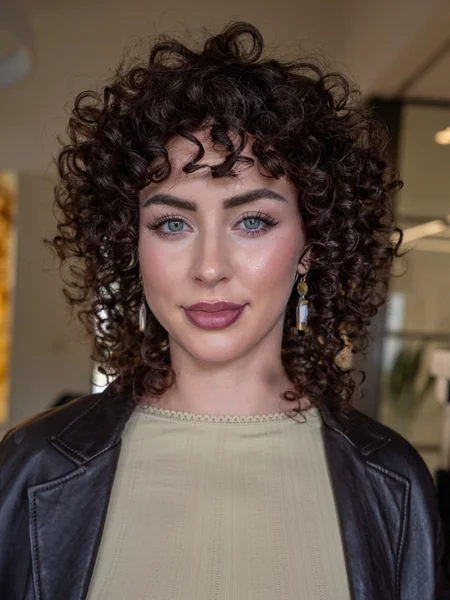 Curly Shag Haircut with Face-Framing Bangs