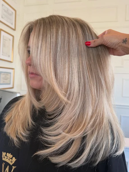 Long Layered Blonde Haircut with Movement