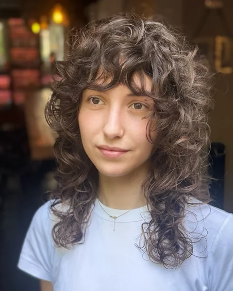 Curly Shag Haircut with Curtain Bangs