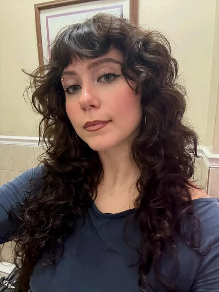 Dark Curly Shag Haircut with Fringe