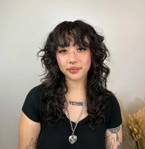 Curly Shag Haircut with Full Bangs
