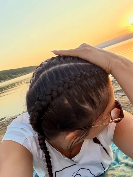 Two Braids At Sunset On The Beach