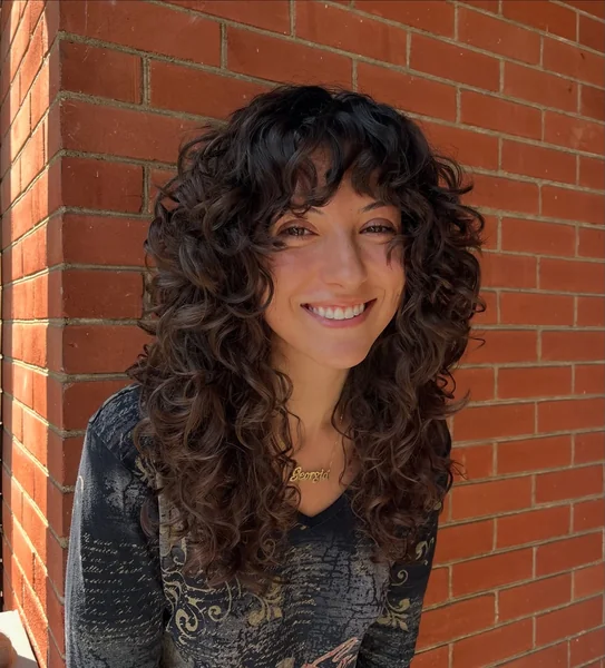 Curly Shag Haircut with Full Bangs