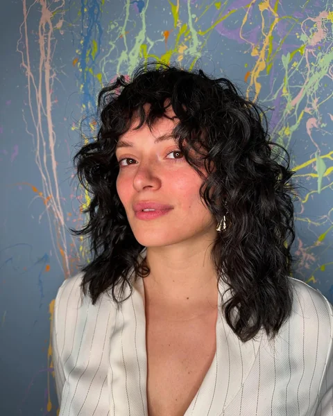 Dark Curly Shag Haircut with Bangs