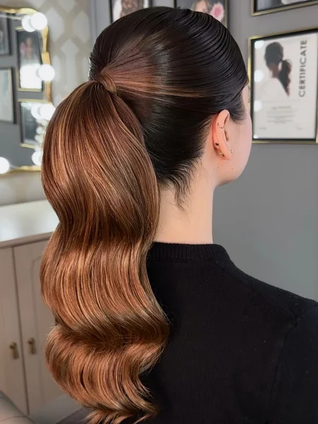 Sleek Wet-Look Ponytail With Waves
