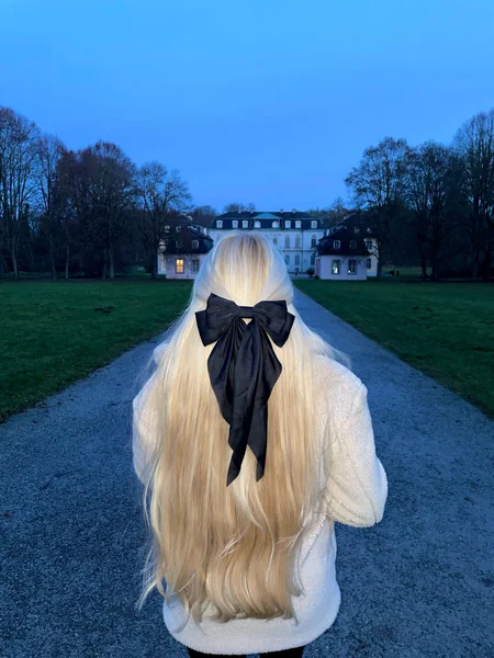 Half-Up Blonde Hair with Black Ribbon