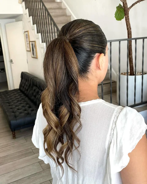 Sleek Slickback Ponytail with Curls