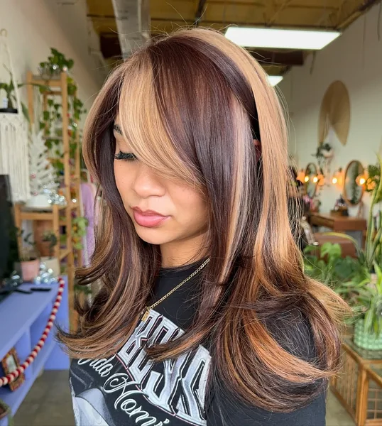 Swoopy Side Bangs with Caramel Streaks
