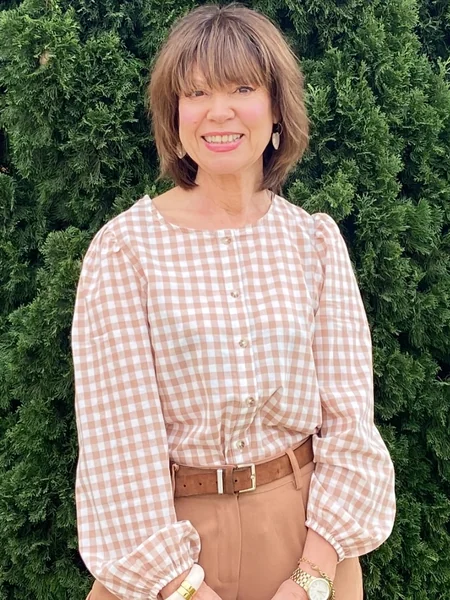 5. Brunette Layered Bob with Full Bangs
