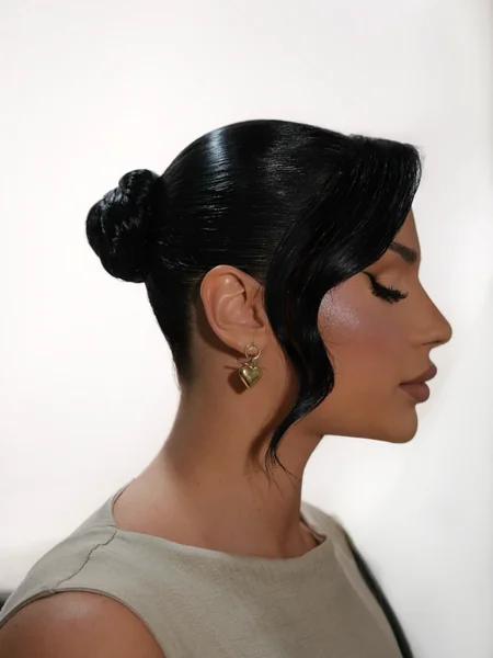 Wet-Look Low Bun with Face-Framing Strand