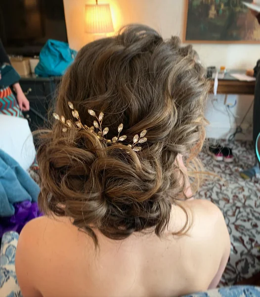 Messy Wavy Bridal Bun With Gold Pin