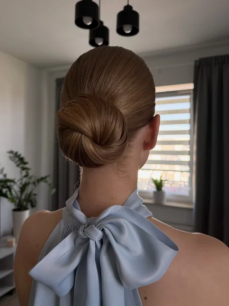 Sleek Twisted Bun for Wedding Guests