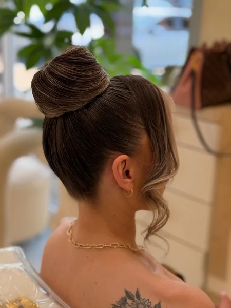 Smooth High Bun with Face-Framing Pieces