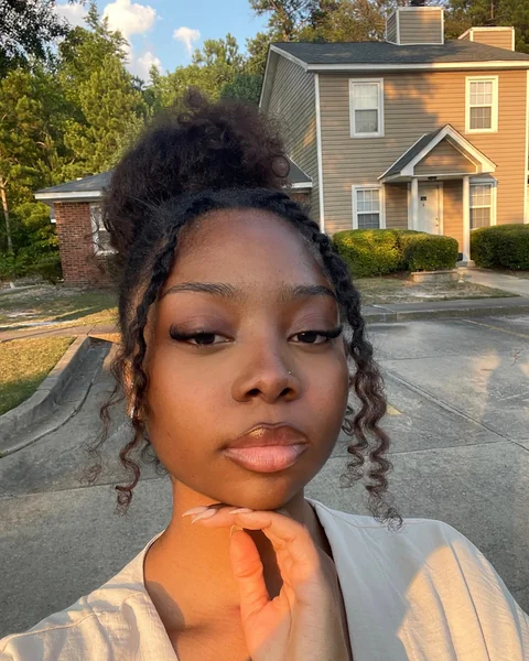 Curly High Bun with Twisted Tendrils