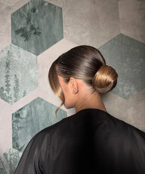 Sleek Low Bun with Swept Strands
