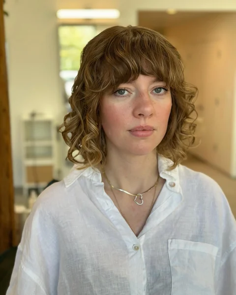 Auburn Curly Bob with Full Bangs