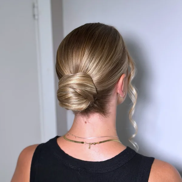 Knotted Low Bun with Face-Framing Waves