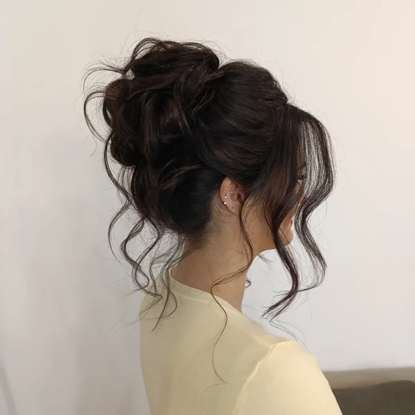 Messy High Bun with Wispy Bangs
