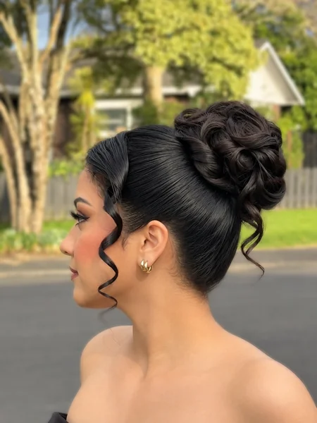 Sleek High Curled Bun with Sculpted Tendril