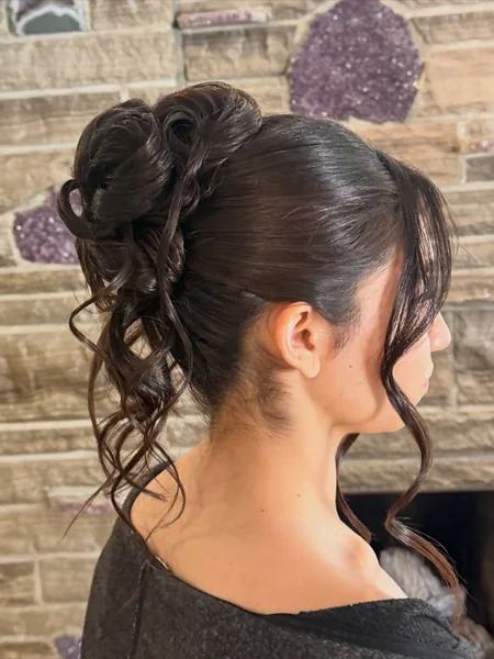 High Curled Updo with Face-Framing Tendrils