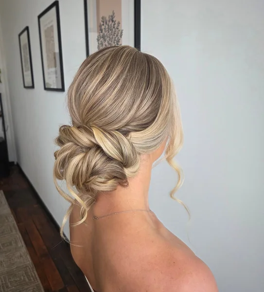 Low Twisted Chignon with Soft Tendrils
