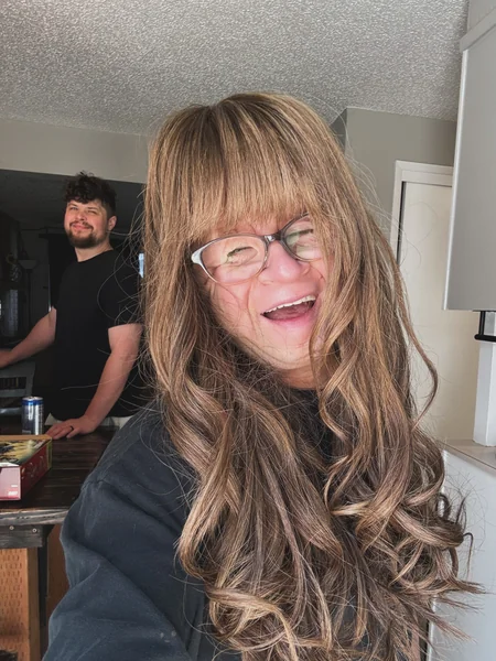 15. Long Curls with Full Bangs