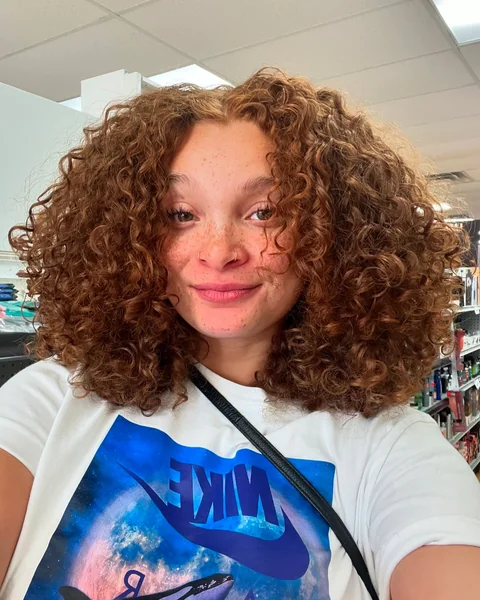 Voluminous Curly Cut at Shoulder Length