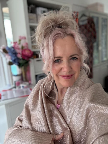 Messy Top Knot with Curled Tendrils
