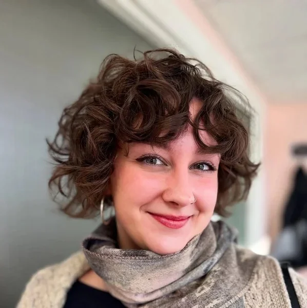 Brunette Curly Bixie with Airy Face Framing Tendrils