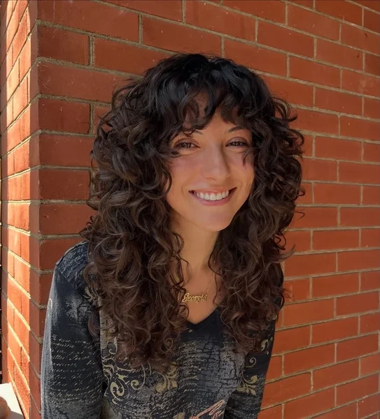 Curly Shag Haircut with Full Bangs