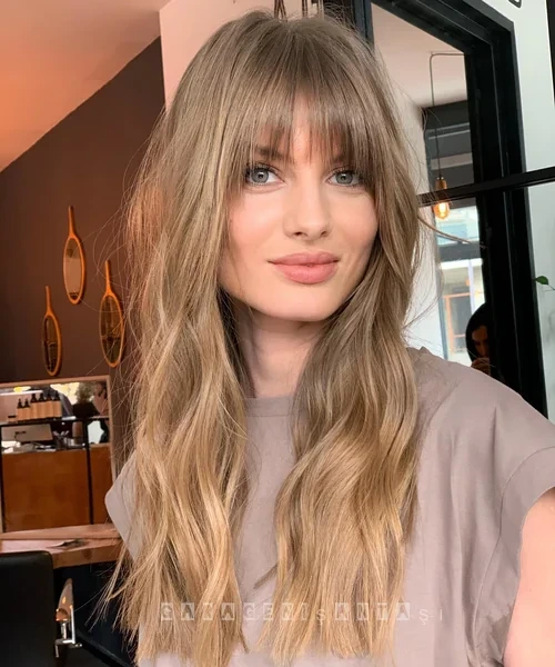 Long Blonde Wavy Hair with Wispy Curtain Bangs