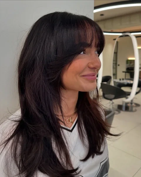 Long Dark Hair with Wispy Curtain Bangs Side Profile